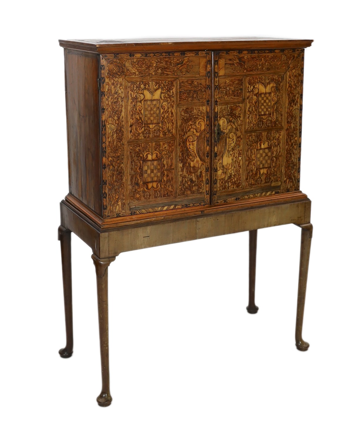 A 17th century and later South German walnut and marquetry cabinet on later stand, width 110cm, depth 53cm, height 153cm